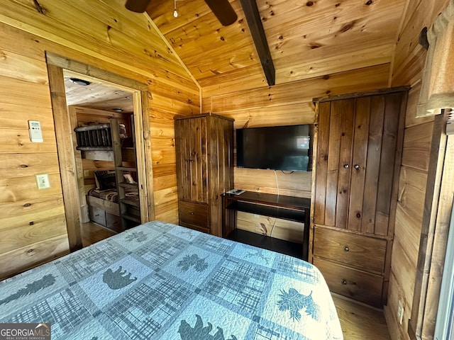 bedroom with vaulted ceiling with beams, wood ceiling, wood finished floors, and wooden walls