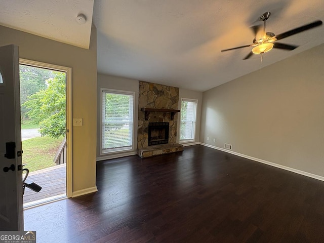 1231 Providence Way, Lawrenceville, GA 30046 - unfurnished living room with dark wood-style flooring, vaulted ceiling, a ceiling fan, and a stone fireplace