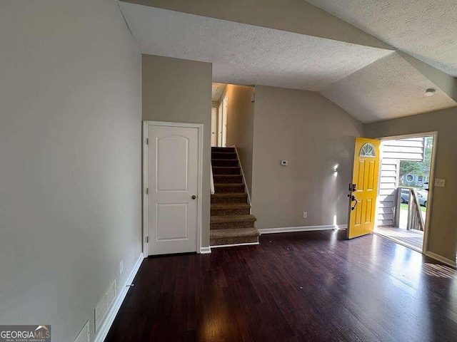 1231 Providence Way, Lawrenceville, GA 30046 - unfurnished living room featuring a textured ceiling, wood finished floors, lofted ceiling, and stairway