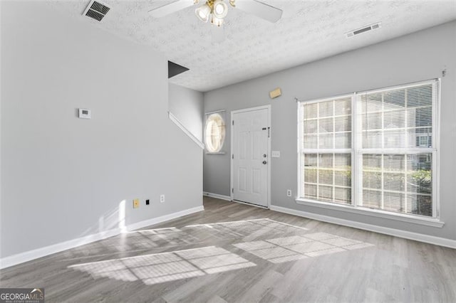 6099 Camden Forrest Cv, Riverdale, GA 30296 - entryway with a textured ceiling, baseboards, wood finished floors, and visible vents