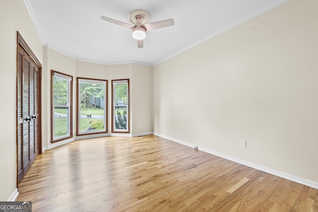 empty room featuring baseboards, ceiling fan, and light wood finished floors