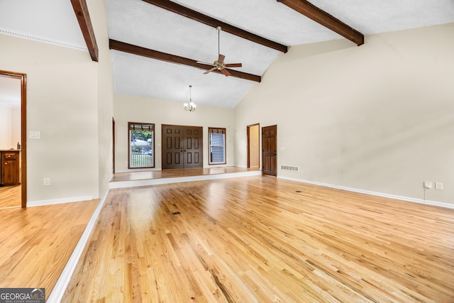 unfurnished living room featuring visible vents, light wood-style flooring, ceiling fan with notable chandelier, and beam ceiling