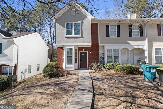 6093 Camden Forrest Ct, Riverdale, GA 30296 - view of front facade with brick siding, stucco siding, and a chimney