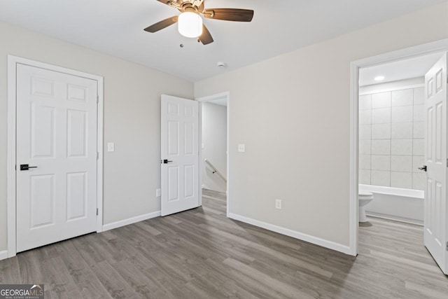 6093 Camden Forrest Ct, Riverdale, GA 30296 - unfurnished bedroom with baseboards and wood finished floors