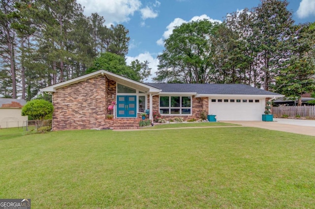 view of front of house with concrete driveway, an attached garage, fence, and a front yard