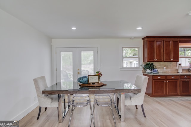 dining room with baseboards, french doors, recessed lighting, and light wood-style flooring