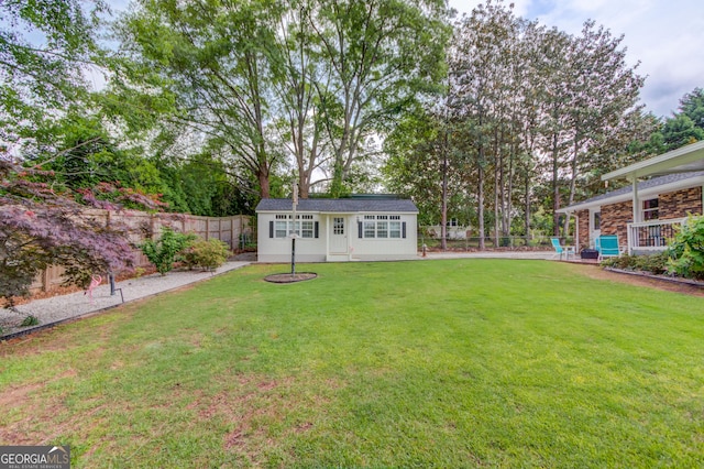 view of yard featuring a fenced backyard and an outbuilding
