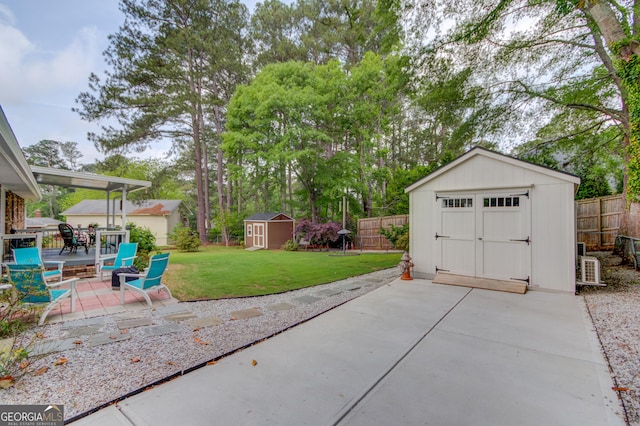 view of patio / terrace featuring an outdoor structure, a fenced backyard, and a storage shed