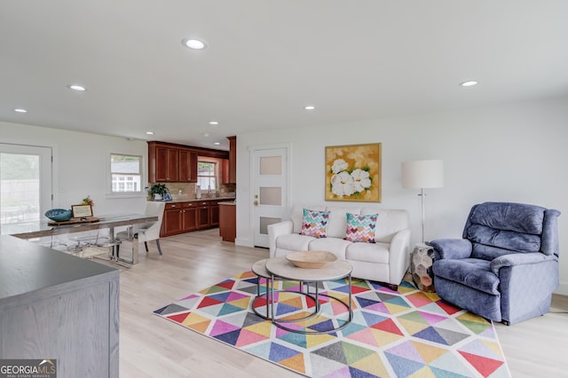 living area with recessed lighting and light wood-type flooring