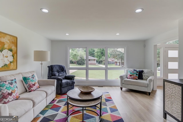 living area with recessed lighting, plenty of natural light, and light wood-type flooring