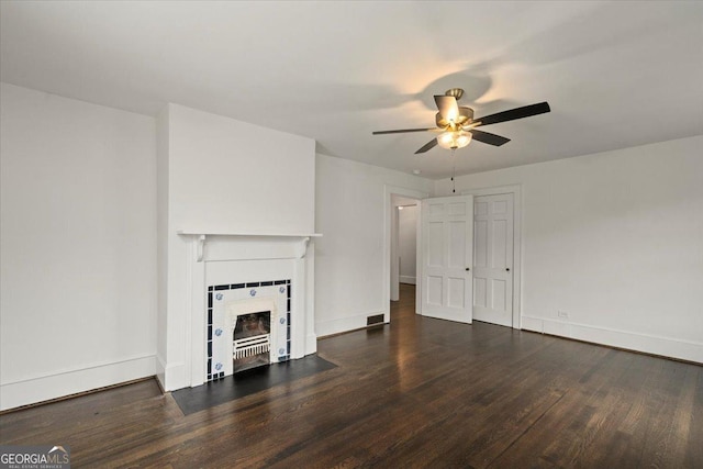 6104 Floyd St NE, Covington, GA 30014 - unfurnished living room featuring a ceiling fan, wood finished floors, a tile fireplace, and baseboards