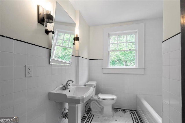 6104 Floyd St NE, Covington, GA 30014 - full bath with tile walls, toilet, tile patterned floors, a bath, and a sink