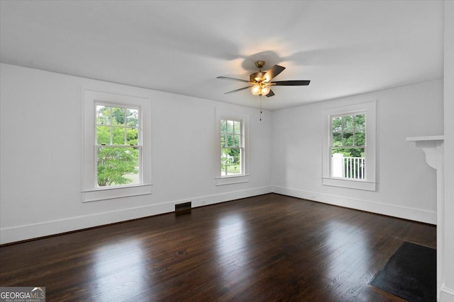 6104 Floyd St NE, Covington, GA 30014 - empty room featuring dark wood-style flooring, ceiling fan, and baseboards