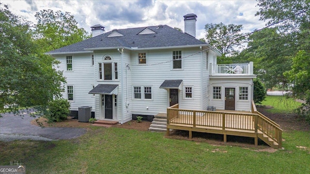 6104 Floyd St NE, Covington, GA 30014 - back of house featuring a balcony, a chimney, central AC, and a lawn