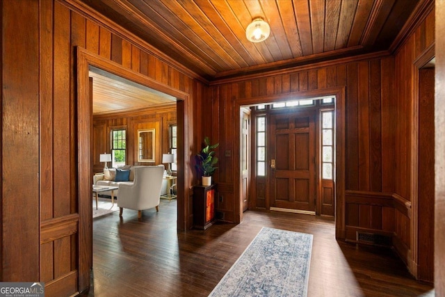 6104 Floyd St NE, Covington, GA 30014 - entrance foyer featuring wood ceiling, wooden walls, crown molding, and dark wood-style floors