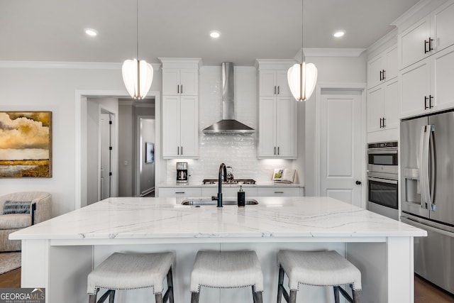 kitchen with a kitchen breakfast bar, tasteful backsplash, a sink, stainless steel fridge with ice dispenser, and wall chimney exhaust hood
