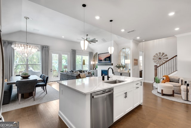 kitchen featuring a sink, open floor plan, stainless steel dishwasher, vaulted ceiling, and dark wood-style floors