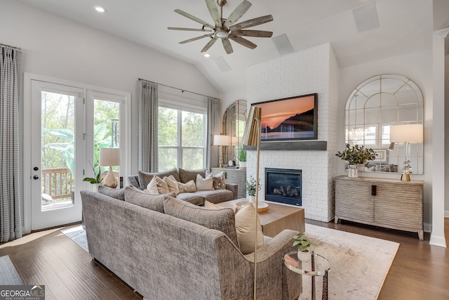 living room featuring wood finished floors, lofted ceiling, a fireplace, ceiling fan, and recessed lighting