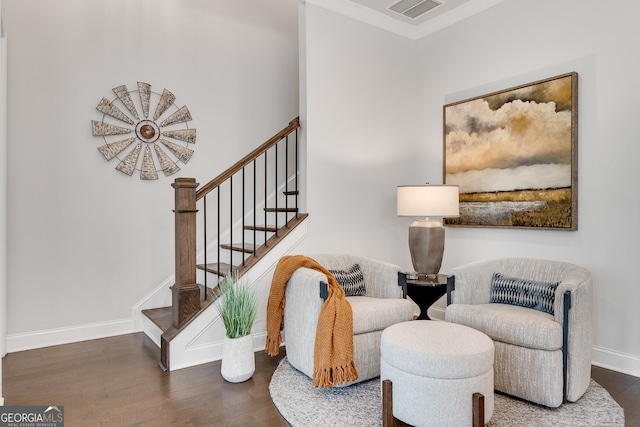 sitting room featuring stairs, baseboards, visible vents, and wood finished floors