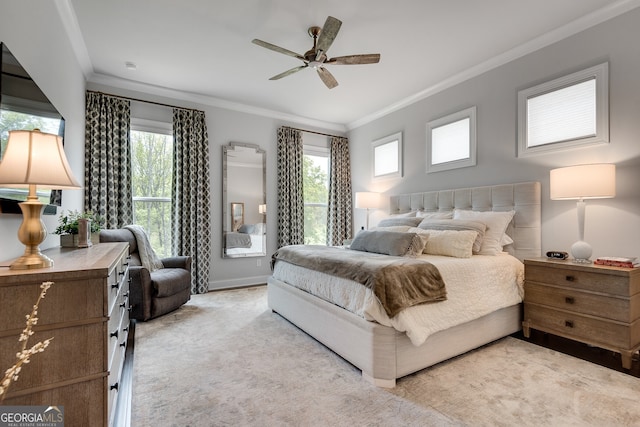 bedroom with a ceiling fan, light colored carpet, and ornamental molding