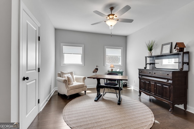 living area featuring baseboards, dark wood-style flooring, and ceiling fan
