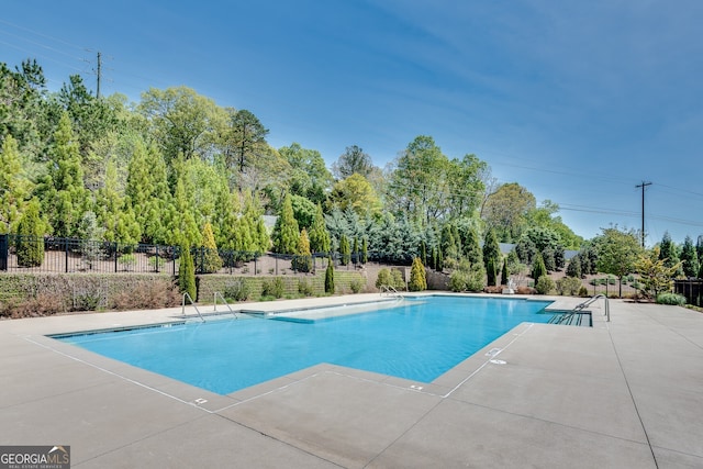 pool featuring a patio area and fence