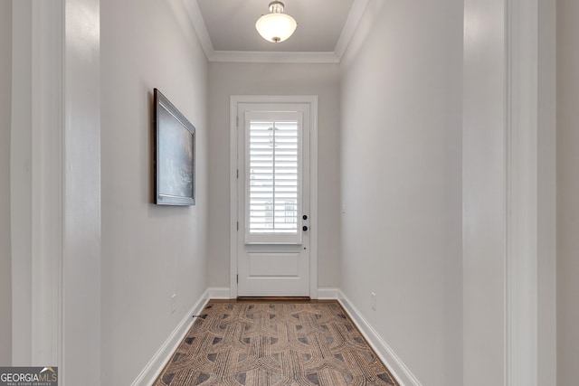 doorway to outside featuring baseboards and ornamental molding