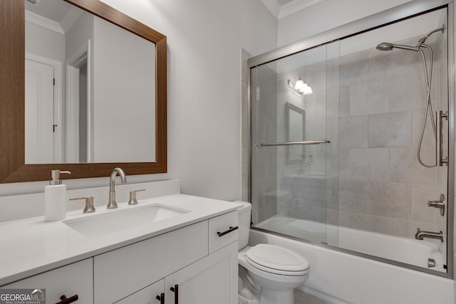 bathroom with vanity, ornamental molding, enclosed tub / shower combo, and toilet