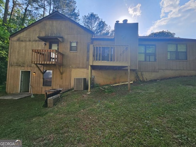 exterior space with a yard, central AC, and a chimney