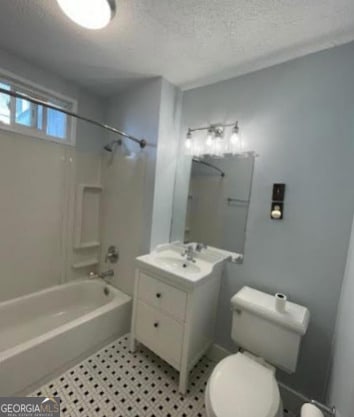 full bathroom with a textured ceiling, vanity, toilet, and shower / tub combination