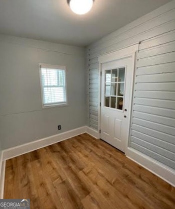 entryway featuring baseboards and wood finished floors