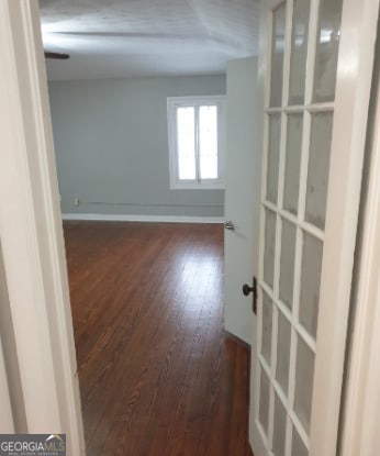 empty room featuring baseboards and wood finished floors