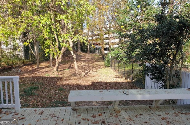 view of yard featuring fence and a wooden deck