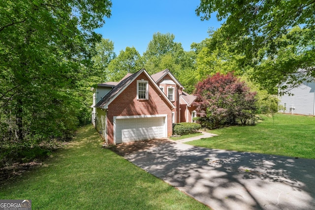 traditional-style home with a garage, concrete driveway, a front lawn, and brick siding