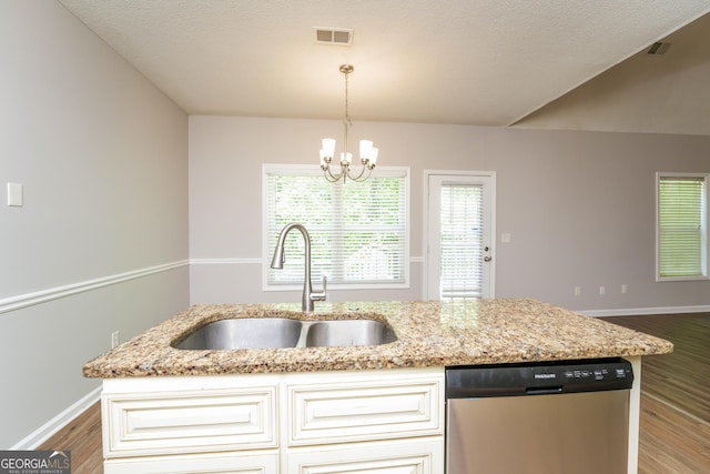 kitchen with visible vents, wood finished floors, light stone countertops, a sink, and dishwasher