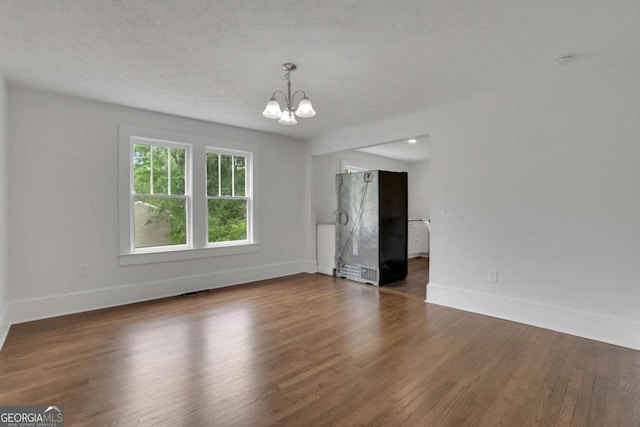 3223 Cleveland Hwy, Gainesville, GA 30506 - spare room featuring a chandelier and wood finished floors