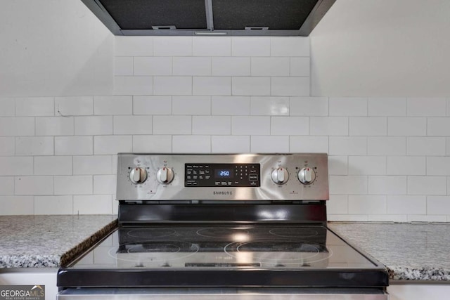 3223 Cleveland Hwy, Gainesville, GA 30506 - interior details featuring backsplash, electric range, light stone counters, and ventilation hood