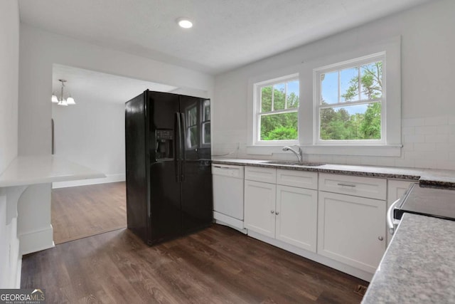 3223 Cleveland Hwy, Gainesville, GA 30506 - kitchen with white dishwasher, black fridge, dark wood-style floors, white cabinets, and a chandelier