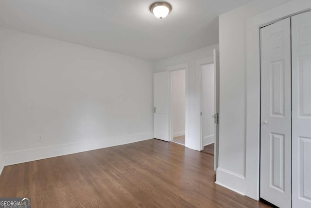 3223 Cleveland Hwy, Gainesville, GA 30506 - unfurnished bedroom featuring baseboards, a closet, and dark wood-style floors