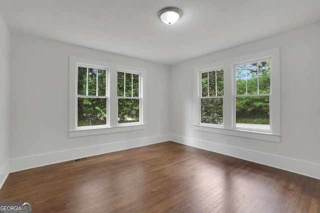 3223 Cleveland Hwy, Gainesville, GA 30506 - spare room with baseboards, visible vents, a healthy amount of sunlight, and dark wood finished floors