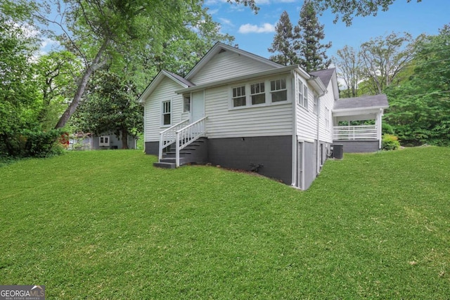 3223 Cleveland Hwy, Gainesville, GA 30506 - back of house featuring a lawn and central AC