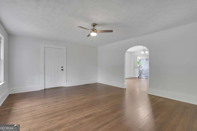 3223 Cleveland Hwy, Gainesville, GA 30506 - empty room featuring arched walkways, ceiling fan, a textured ceiling, and wood finished floors