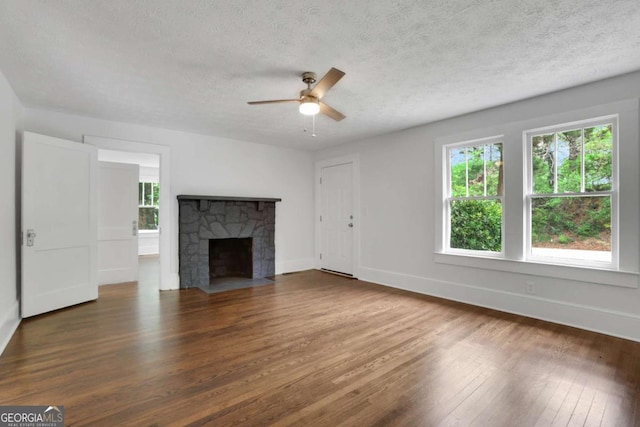 3223 Cleveland Hwy, Gainesville, GA 30506 - unfurnished living room with ceiling fan, a textured ceiling, a fireplace, wood finished floors, and baseboards