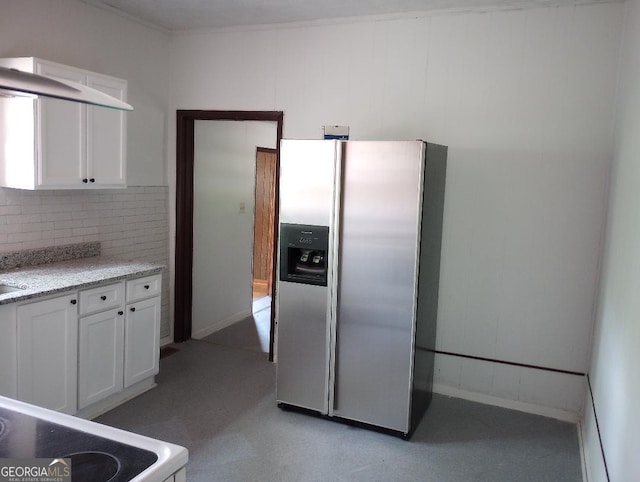 kitchen with decorative backsplash, light stone countertops, stainless steel refrigerator with ice dispenser, and white cabinetry