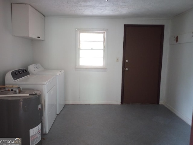 laundry area featuring a textured ceiling, cabinet space, water heater, and washing machine and clothes dryer