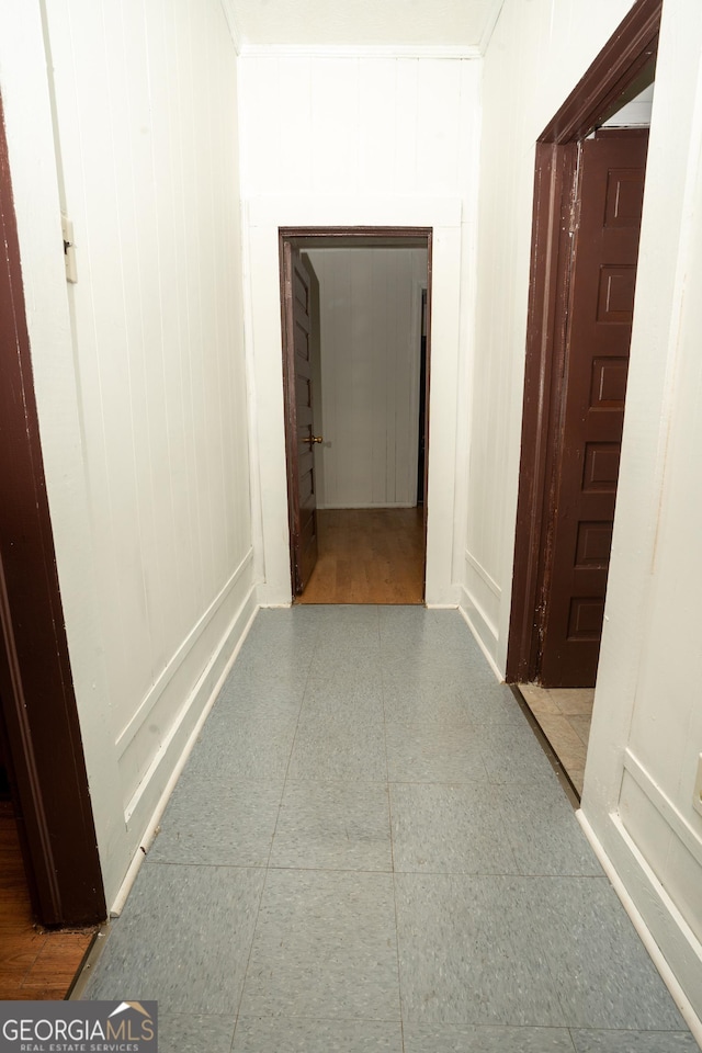 305 Wolfe St, Dublin, GA 31021 - unfurnished living room with a brick fireplace, wooden walls, visible vents, and light wood-style floors