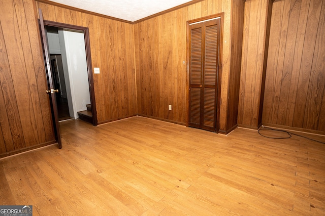 unfurnished bedroom featuring wood walls and wood finished floors