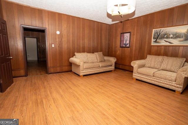 305 Wolfe St, Dublin, GA 31021 - living room featuring wood walls and light wood-style flooring