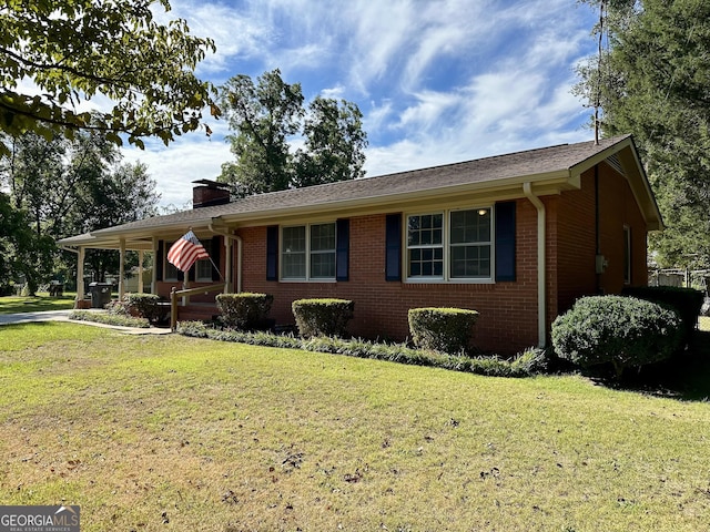 111 Howard St, Byron, GA 31008 - ranch-style home with brick siding, a chimney, and a front yard