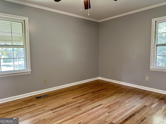 111 Howard St, Byron, GA 31008 - spare room featuring crown molding, ceiling fan, baseboards, wood finished floors, and visible vents